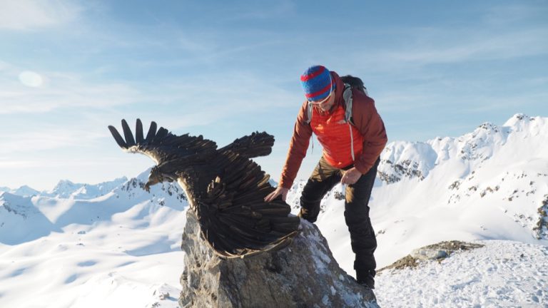 Artist Walter File with his sculpture in the Alps